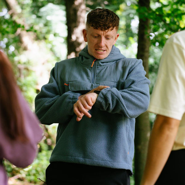 Person wearing a blue Portwest fleece jacket in a forest setting